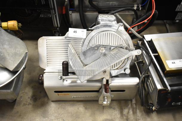 Globe stainless steel commercial meat slicer with sharpening blade, 115V, 1 Phase, countertop model in used condition.