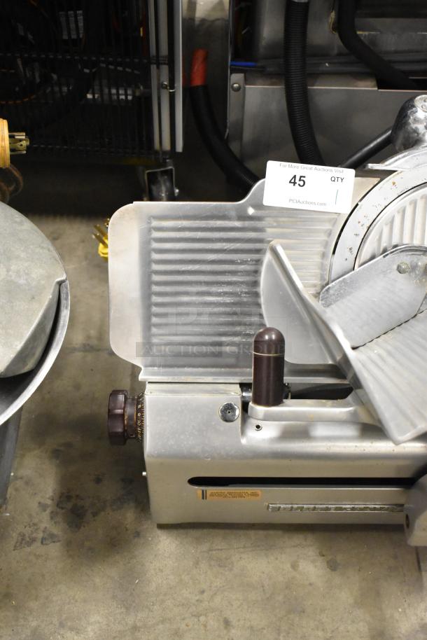 Globe stainless steel commercial countertop meat slicer with sharpening blade, 115 volts, 1 phase, model tag visible.