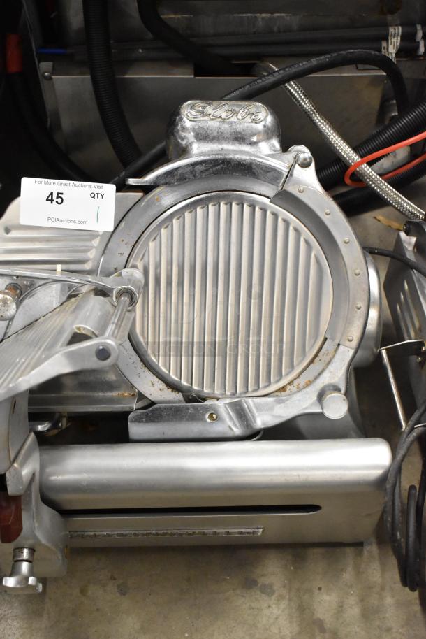 Globe stainless steel commercial countertop meat slicer with sharpening blade, 115V, 1 phase. Visible slight wear.