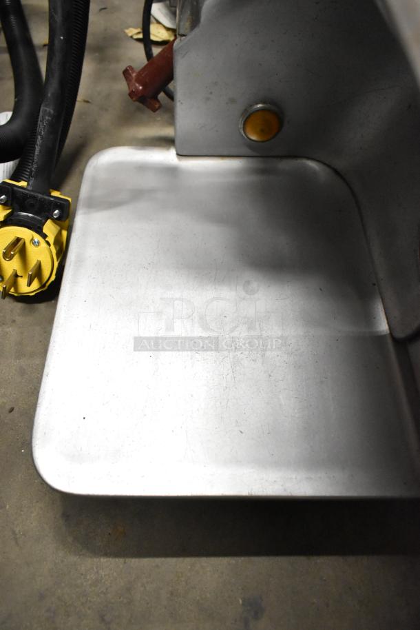 Globe stainless steel commercial meat slicer with sharpening blade, countertop model. Used, 115 volts, 1 phase.