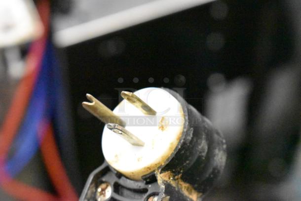 Stainless steel power plug for Globe meat slicer, 115 volts, 1 phase, showing minor wear.