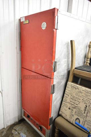 Cres-Cor Crown-X H-137-UA-12 heated holding cabinet, red metal, with visible wear, on commercial casters, 115V, 1 phase.