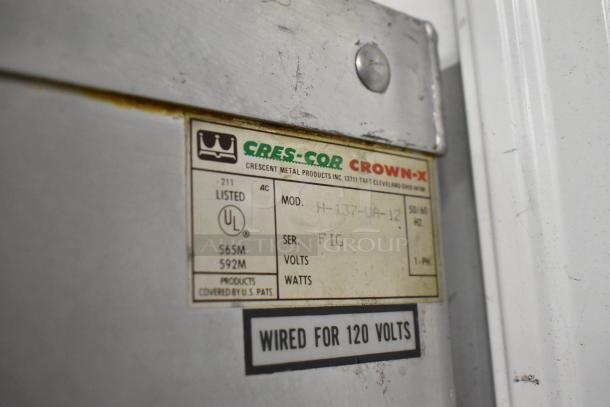 Cres-Cor Crown-X H-137-UA-12 heated holding cabinet, 115V, 1 phase, on casters, metal build, features product and voltage label.