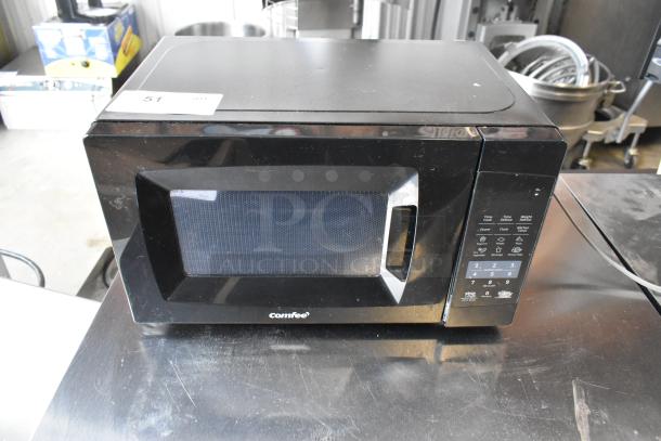 2020 Comfee EM720CPL-PMB countertop microwave oven. Black finish, digital control panel. Slight wear, 120 volts, 1 phase.