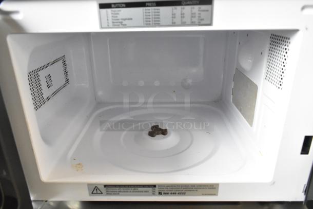 2020 Comfee EM720CPL-PMB Microwave Oven interior, clean condition, 120 volts, part of control label visible at top.
