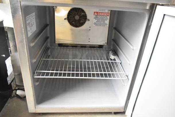 2020 Delfield 406P-STAR2 stainless steel undercounter cooler, single door, includes commercial casters, visible warning labels.