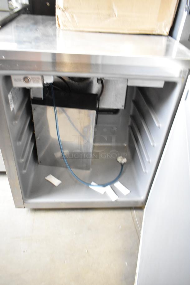 Delfield Welbilt ND21RS00B stainless steel undercounter cooler, 1 door, 115V, internal shelving grooves, open door.