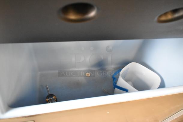 Ice-O-Matic CIM1446HR5 stainless steel commercial ice head on a bin, shown empty, with a bucket inside. 208-230V, 1 phase.