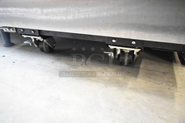 2019 True TG1R-1SLH-HC stainless steel cooler on commercial casters, showcasing bottom detail.