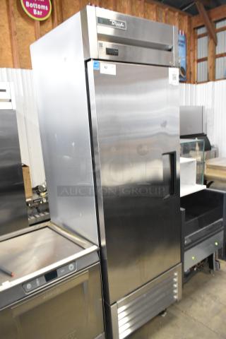 True stainless steel commercial reach-in freezer, single door, 115 volts, 1 phase. Display tag on door. Used condition.