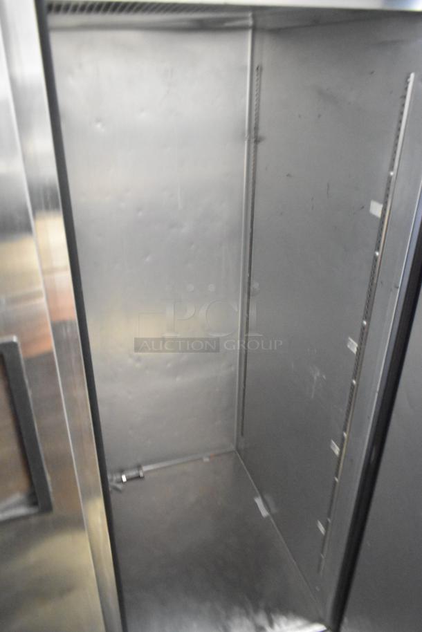 2018 True TG2R-2S-HC stainless steel commercial cooler interior, featuring poly-coated racks and casters, 115V, 1 phase.