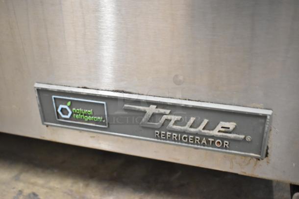 2023 True TUC-27-HC stainless steel undercounter cooler with natural refrigerant label, on commercial casters.