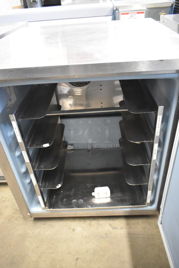 2016 Delfield stainless steel undercounter cooler with single door, shelves, and commercial casters. Model 115 volts, 1 phase.