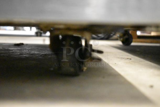 2016 Delfield stainless steel undercounter cooler on casters, showing base and wheels, 115V, 1 Phase, commercial use.