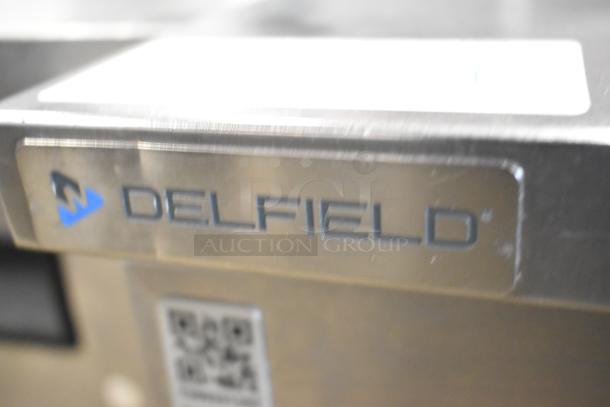 2020 Delfield 406P-STAR2 stainless steel undercounter cooler, single door, on commercial casters, 115V, shown with logo.