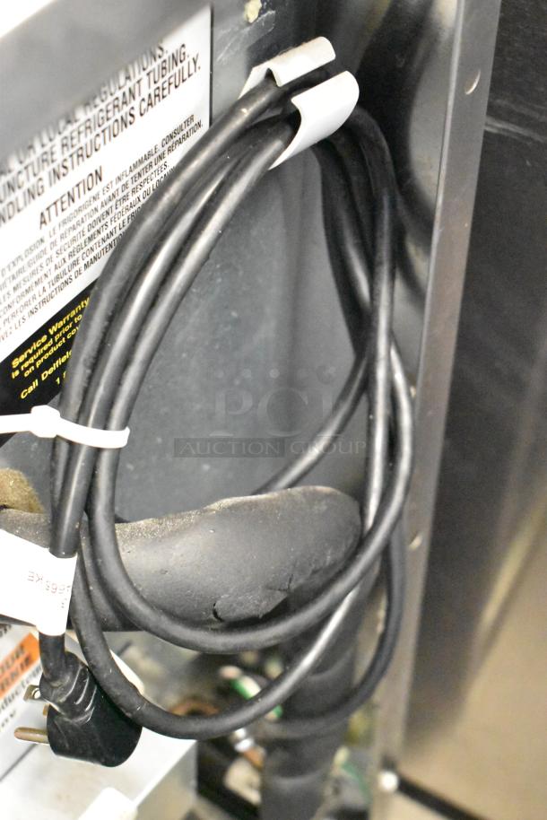 Close-up of power cord and components for 2020 Delfield 406P-STAR2 stainless steel commercial undercounter cooler.