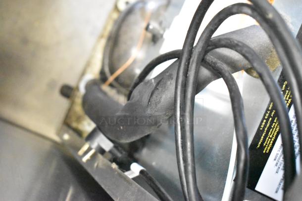 Delfield 406P-STAR2 cooler, stainless steel, single door, on casters. Power cord and internal components visible.