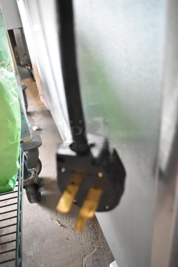 Close-up of a power cord for the 2023 Ice-O-Matic CIM1446HR6 Stainless Steel Commercial Ice Head, showing three-prong plug.