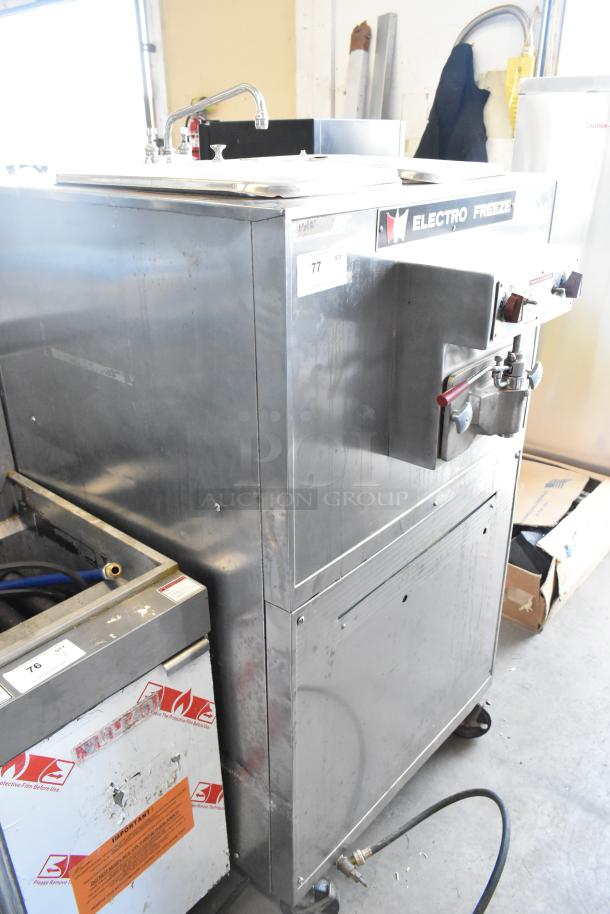 Electro Freeze 88TF stainless steel floor batch freezer, commercial casters, 230V, 1 phase, visible controls and spout.