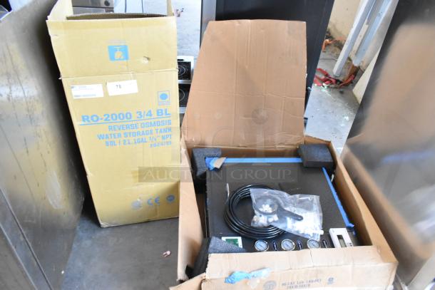 Two brand new RO-2000 Reverse Osmosis units, one in box, with visible gauges and tank, labeled for commercial use.