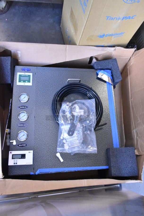 Brand new RO-2000 water storage tank with wall mount commercial reverse osmosis system in box, gauges visible.