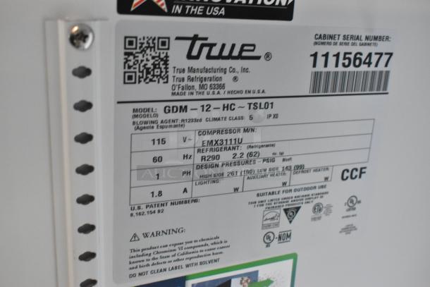 Alt text: Label close-up on a True GDM-12-HC commercial cooler, showing model, voltage 115V, and refrigerant R290 details.