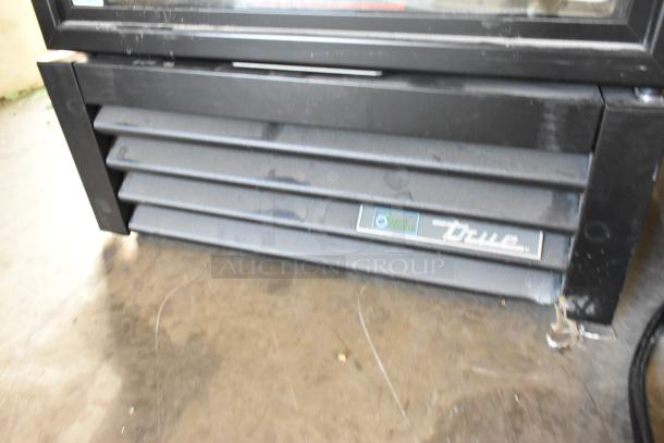 Brand new 2025 True GDM-12-HC reach-in cooler. Metal commercial unit with poly-coated racks, slight scratches, 115V, 1 phase.