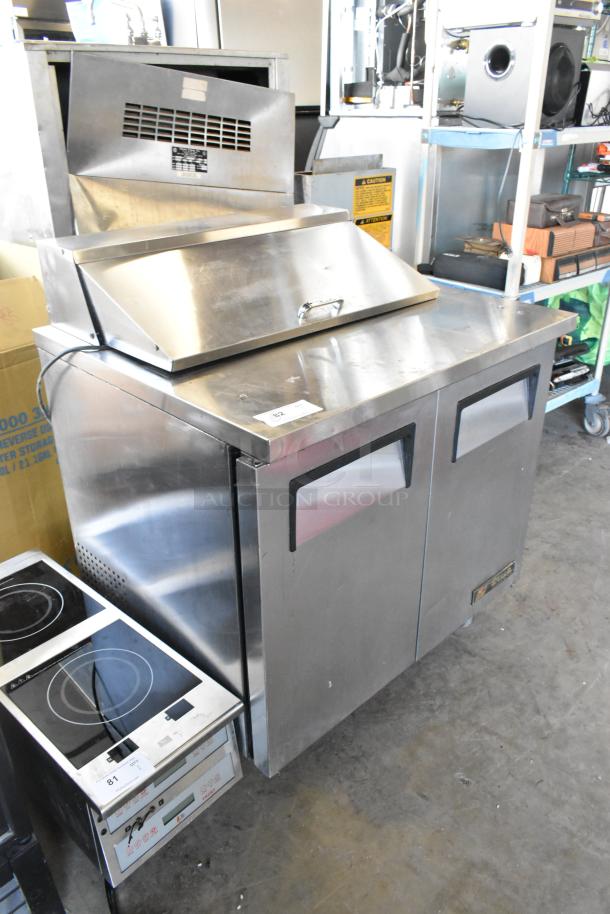 True TSSU-36-08 stainless steel sandwich salad prep table on casters, with hinged top and dual doors. 115V, 1 phase.