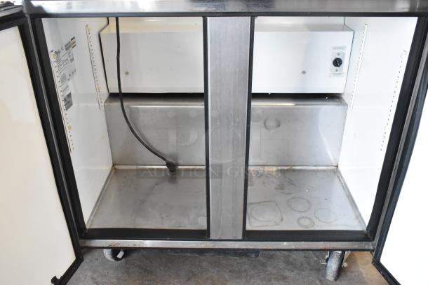 True TSSU-36-08 stainless steel prep table, empty interior view, 115V, on commercial casters. Includes shelf guides and power cord.