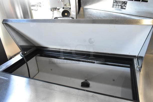 True TSSU-36-08 stainless steel prep table with open top, interior view, on commercial casters, 115 volts, 1 phase.