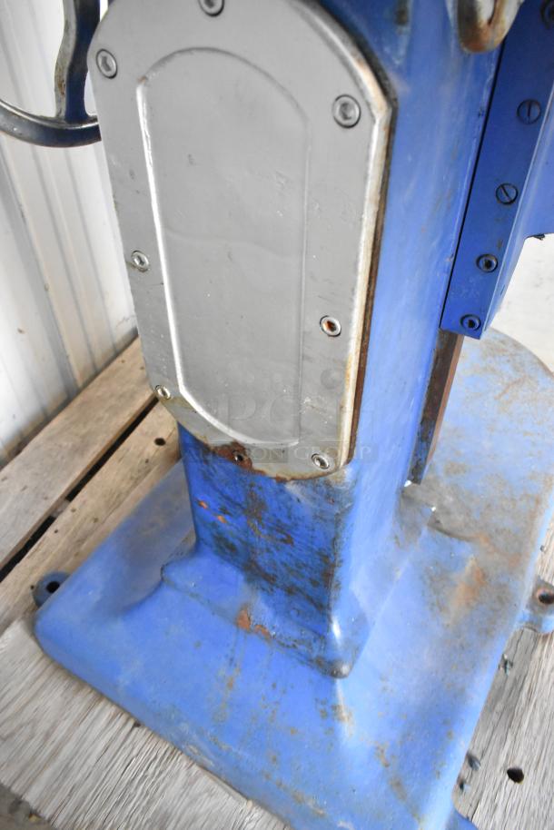 Metal commercial planetary dough mixer base, blue with visible wear, sturdy construction, suitable for heavy-duty use.