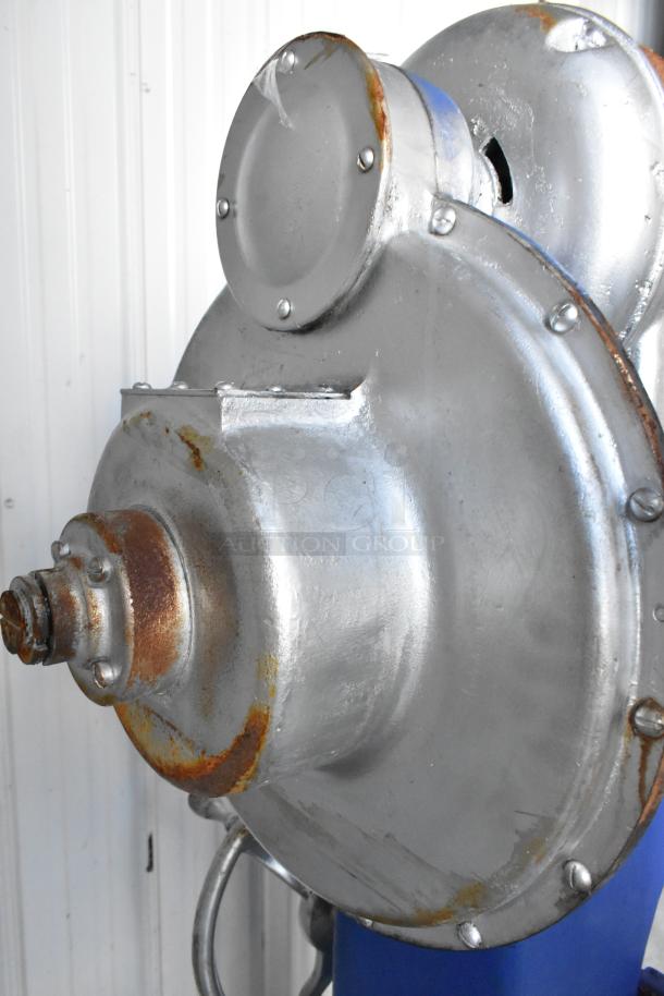 Metal commercial floor-style planetary dough mixer, showcasing signs of rust and wear, suitable for professional use.