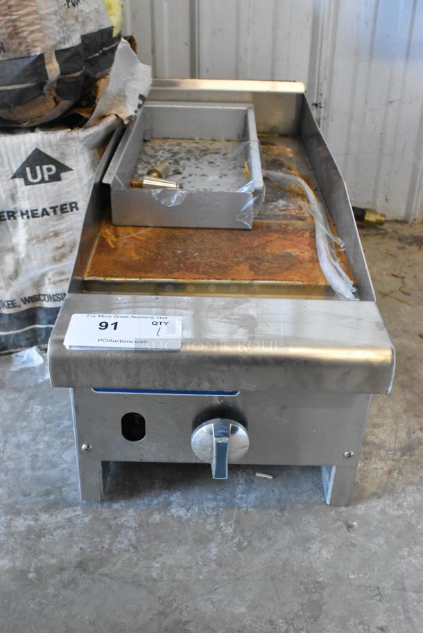 Radiance TAMG-12 stainless steel griddle, natural gas powered, 22,000 BTU, used condition. Auction tag visible.