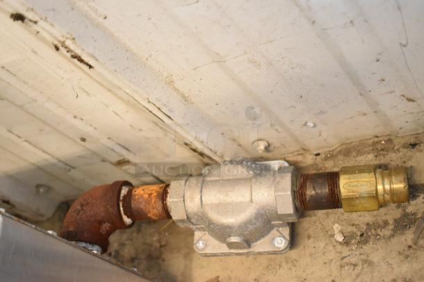 Sorry, the image does not show the Radiance TAMG-12 griddle; it shows a gas pipe connection with rust and a brass fitting.