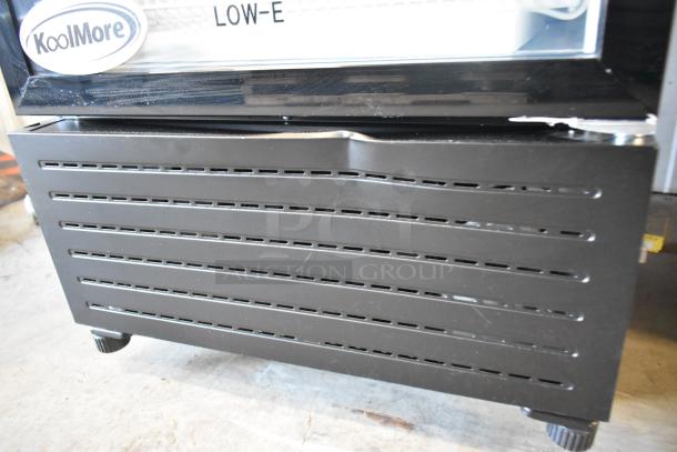 BRAND NEW KoolMore KM-MDR-1GD-10C reach-in cooler with scratch and dent, metal frame, poly coated racks, commercial casters.