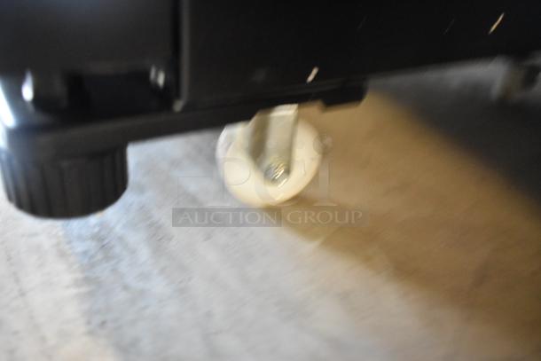 Close-up of a caster wheel on a KoolMore KM-MDR-1GD-10C commercial cooler. The wheel allows easy mobility.