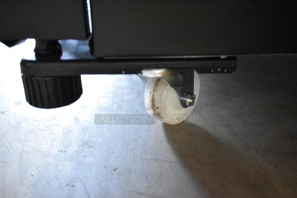 Commercial caster of KoolMore KM-MDR-1GD-10C cooler, showing minor scratches, supports mobility. Poly coated for durability.