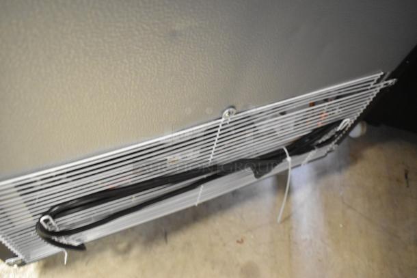 KoolMore KM-MDR-1GD-10C commercial cooler, showing lower metal vent panel and power cord. Scratch and dent condition.