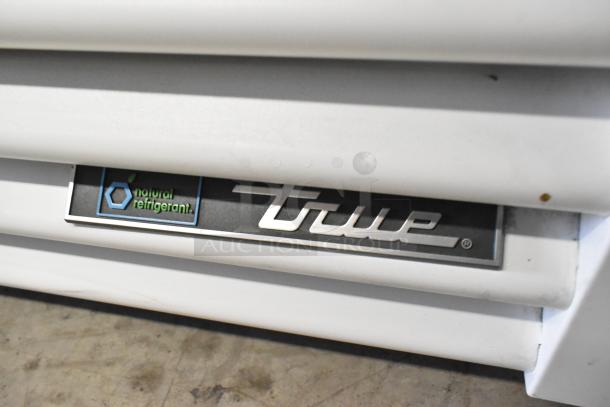 2021 True TSCI-600R-G-PH metal cooler with poly coated racks, 115 volts, 1 phase, natural refrigerant label visible.