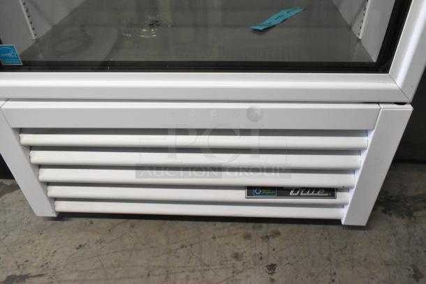 2021 True TSCI-600R-G-PH single door reach-in cooler, metal, with poly coated racks, 115 volts, visible True logo.