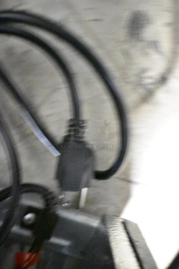 Blurred image of an electrical cord and plug, likely associated with the Frigidaire Gallery FGFRF699 model.