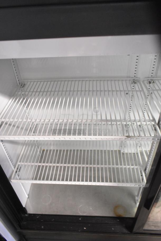 2020 True GDM-41SL-48-HC-LD commercial cooler with 2 glass doors, poly-coated racks, 115 volts, 1 phase, excellent condition.