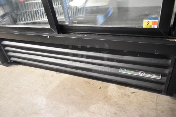 2018 True GDM-41SL-48-HC-LD metal cooler, 2 doors, poly coated racks, 115V, commercial use, black exterior, minor wear.