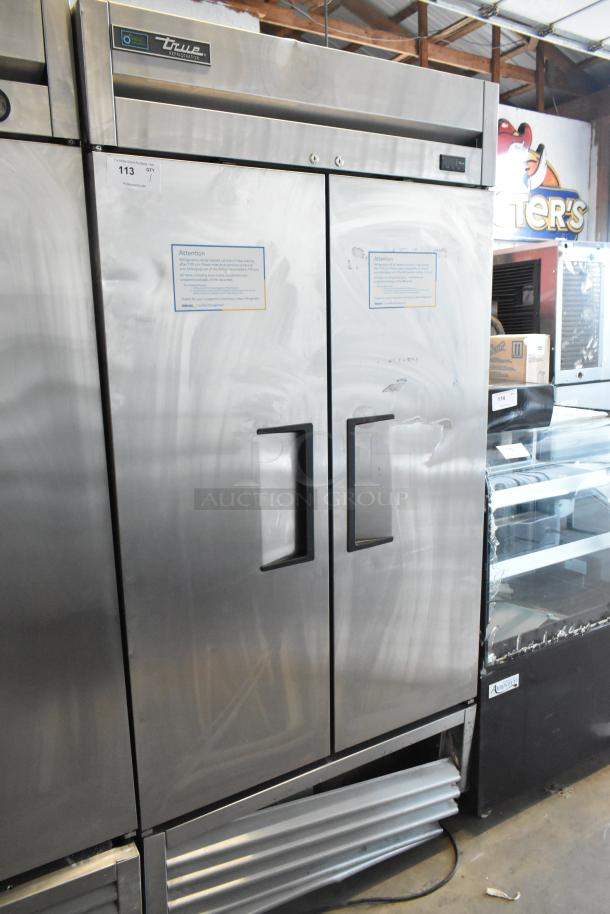 2018 True T-35 stainless steel 2-door reach-in cooler with poly-coated racks, 115 volts, 1 phase. Auction tag visible.