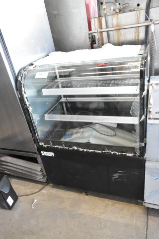 Avantco 193BCD36B black bakery display case with curved glass, minor glass damage visible. New, 115V, 1-phase, 36".