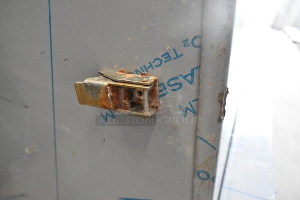 Stainless steel latch on ServIt 423TCW46 chip warmer showing rust and scratches on the surface.