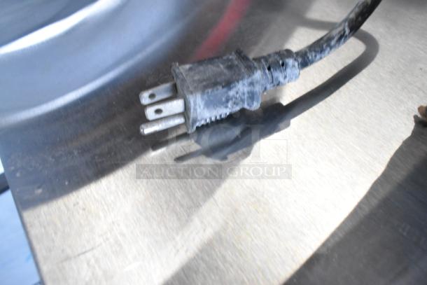 Close-up of a slightly dirty electrical plug for the ServIt 423TCW46 stainless steel chip warmer.