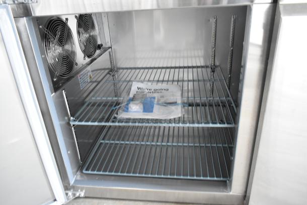 Brand new Avantco 178SSPPT3 stainless steel pizza prep table, 115V, 1 phase. Interior fan and shelving visible.