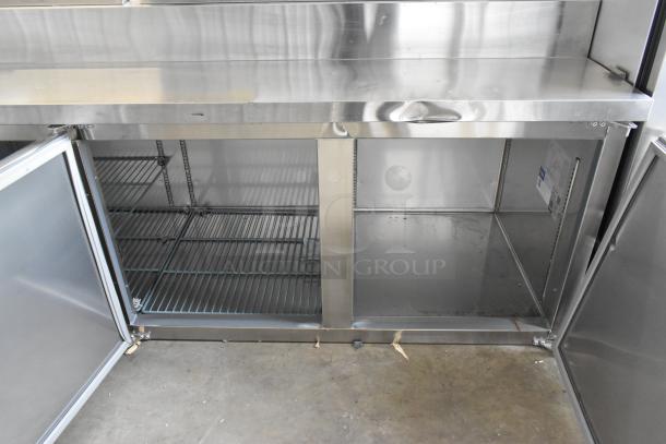 Brand new Avantco 178SSPPT3 stainless steel pizza prep table, 2025 model, showing open storage with minor scratches.