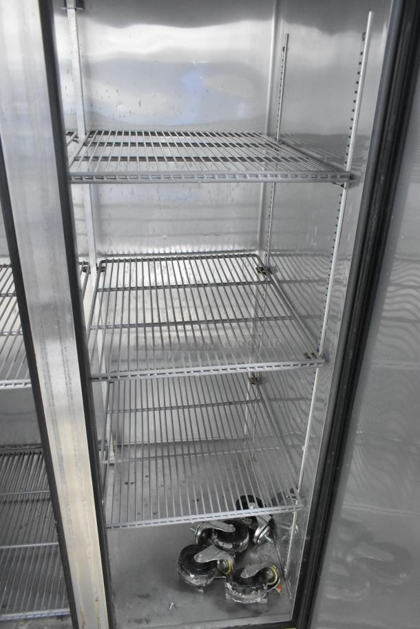 True T-35 stainless steel 2-door reach-in cooler with poly coated racks, 115 volts, 1 phase, clean interior, included casters.